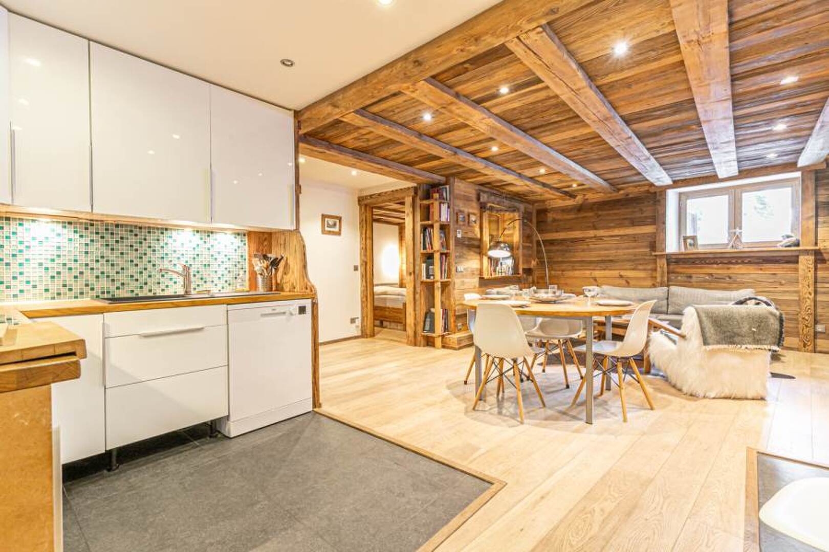 Pièce de vie Edelweiss : cuisine ouverte sur salon avec plafond en vieux bois